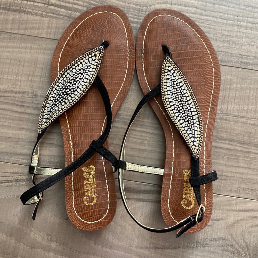 Brown sandals and black straps with gems